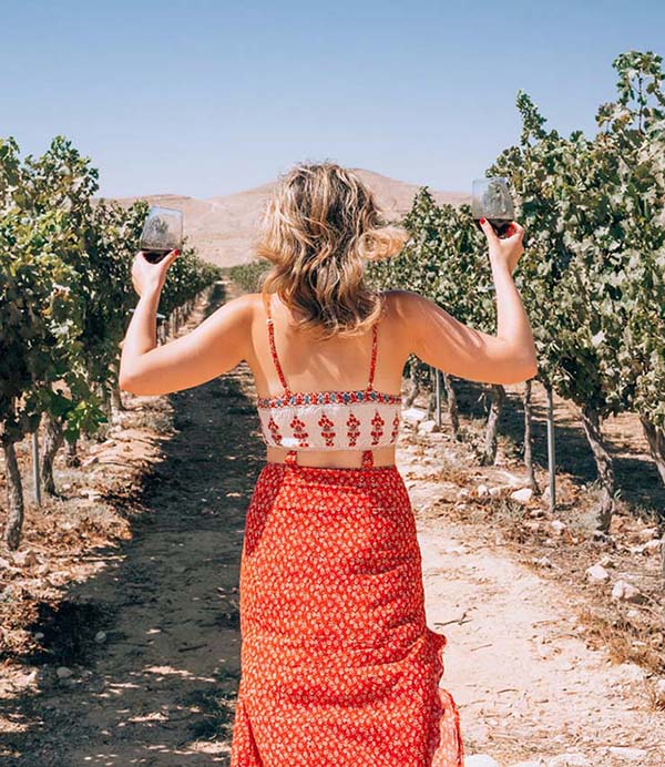 woman at vineyard with wine glass